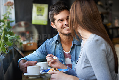 Buy stock photo Shot of a young couple talking in a cafe