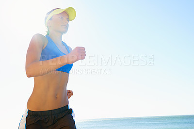 Buy stock photo Fitness, beach and young woman running for race, competition or marathon training exercise. Sports, health and female athlete runner with cardio workout for endurance and speed by ocean or sea.