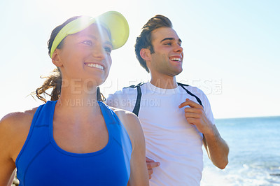 Buy stock photo Couple, running and fitness in beach, morning and active with smile, training and athlete for run. Man, woman and athletic for ocean, sea and exercise together in summer, boyfriend and girlfriend