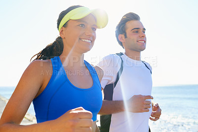 Buy stock photo Happy couple, jog and fitness in beach, workout and active with smile, training and sunrise for run. Man, woman and athletic in ocean, sea and exercise together in summer, morning and health