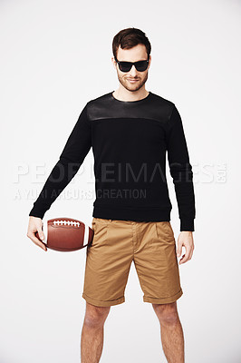 Buy stock photo Sunglasses, fashion and man in studio with football for confident, pride and stylish clothing. Fitness, sport and portrait of male person with ball in funky, cool and trendy style on white background