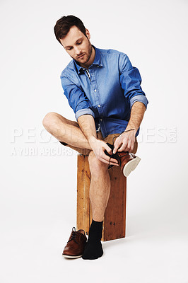 Buy stock photo Fashion, shoes and man in studio against white background for getting ready or dressing. Socks, choice and casual male with outfit for style, decision and fashionable or trendy clothing aesthetic