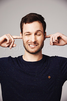 Buy stock photo Block sound, man and finger in ears of a person loud music problem in a studio. Frustrated, isolated and grey background of a male model pain with closed ear from noise for silence and peace