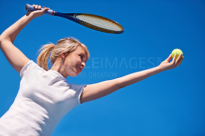 Buy stock photo Tennis, serving and woman in game for sport, competition and playing with ball and racket on blue sky. Athlete, exercise and training outdoor with challenge on court in summer match and contest