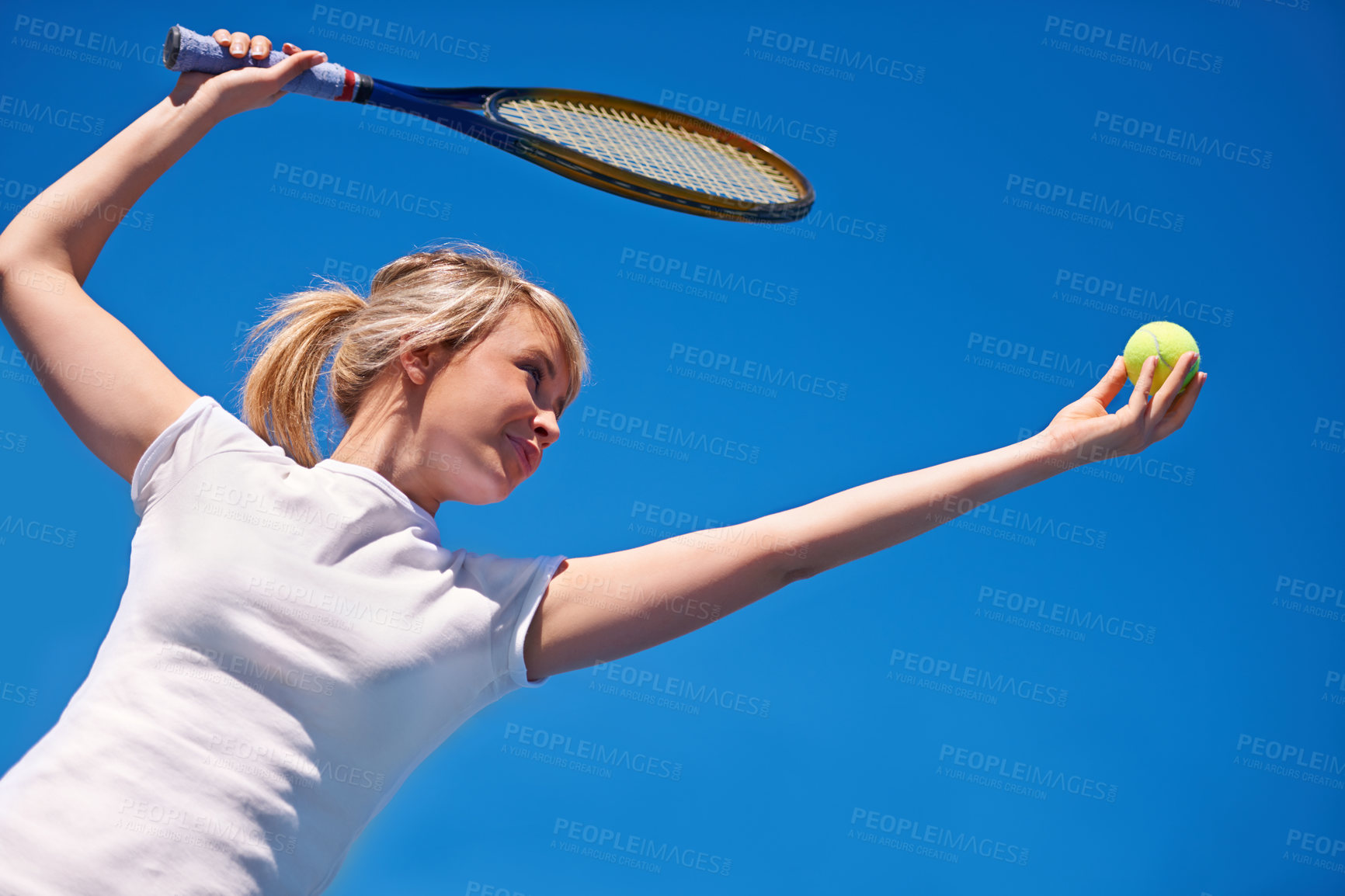 Buy stock photo Tennis, serving and woman in game for sport, competition and playing with ball and racket on blue sky. Athlete, exercise and training outdoor with challenge on court in summer match and contest
