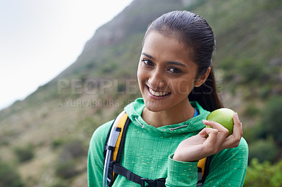 Buy stock photo Cropped view of a young hiker enjoying an apple on the trail