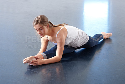 Buy stock photo Ballet, teenager and stretching legs in class, floor and training in dance studio, fitness and exercise. Female person, dancer and strong or flexible, performance and split and warming up technique