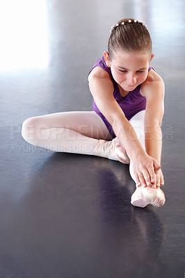 Buy stock photo Ballet, girl and stretching, training for dancing and performance at concert with dancer at academy for education. Creativity, skill and warm up, child ballerina learning with fitness and flexibility