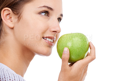 Buy stock photo Woman, eating and apple in hand, nutrition and health with snack, diet for weight loss and detox on white background. Healthy food, wellness and green fruit, vegan and organic with smile in studio