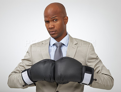 Buy stock photo Studio shot of an african american businessman wearing boxing gloves