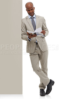 Buy stock photo An African-American businessman paging through a book - isolated