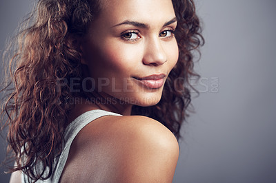 Buy stock photo Studio shot of a gorgeous young woman posing against a gray background