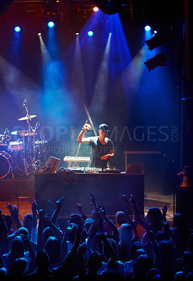 Buy stock photo A DJ playing his live set to a group of screaming fans. This concert was created for the sole purpose of this photo shoot, featuring 300 models and 3 live bands. All people in this shoot are model released.