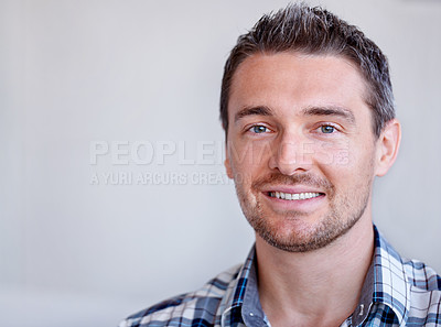Buy stock photo A young man beaming at you confidently