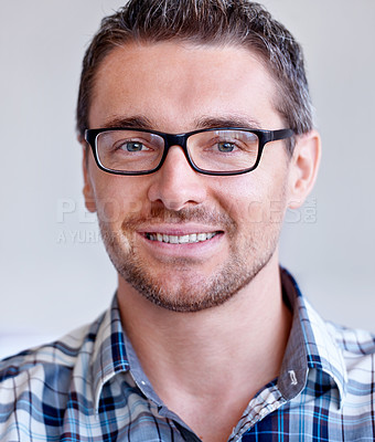 Buy stock photo Smile, entrepreneur or portrait of happy man with glasses, small business or confidence in studio. Face, male designer or employee with pride at startup job, career or company on grey background