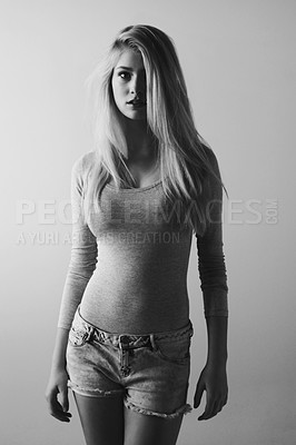 Buy stock photo Black and white image of a beautiful young woman posing in a studio