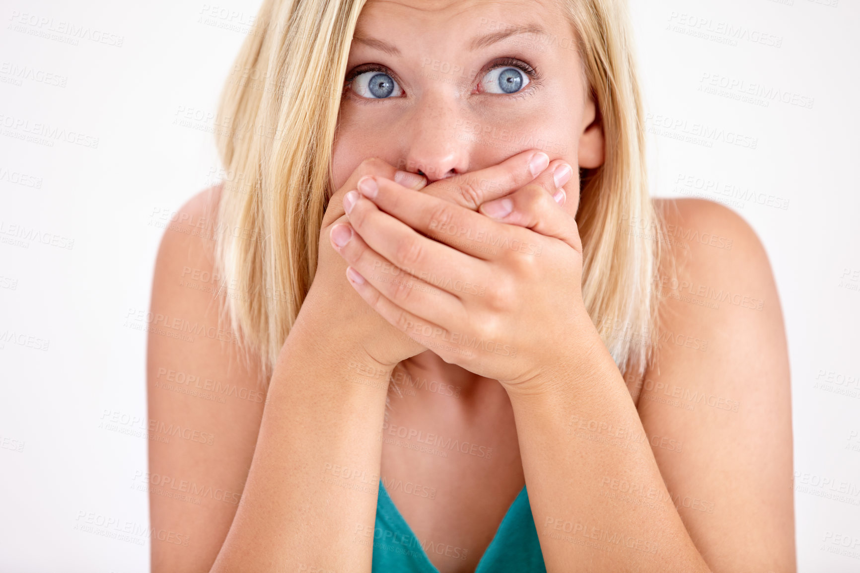 Buy stock photo A young woman holding her mouth in disbelief