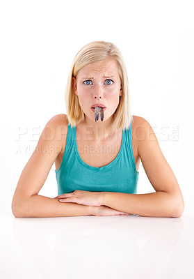 Buy stock photo Confused, woman and portrait of eating fish, tail or strange food in mouth on white background of studio. Crazy, diet and person with weird seafood, cuisine or disgust for taste of tuna or salmon