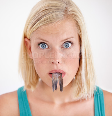 Buy stock photo Portrait, woman and eating tail of fish with surprise and shock on white background of studio. Crazy, diet and person with taste of weird seafood, cuisine and disgust for gross or strange food