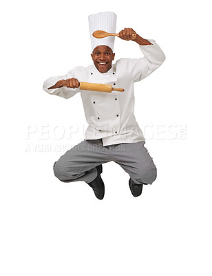 Buy stock photo AN African-American chef jumping in the air holding a roller and a spoon