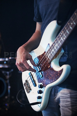 Buy stock photo Cropped shot of a male guitarist playing his guitar