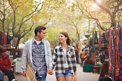 Buy stock photo Happy, walking and couple holding hands on city journey, morning trip or skateboarding tour of urban Paris for outdoor adventure. Love, eye contact and young people bonding together on relax commute