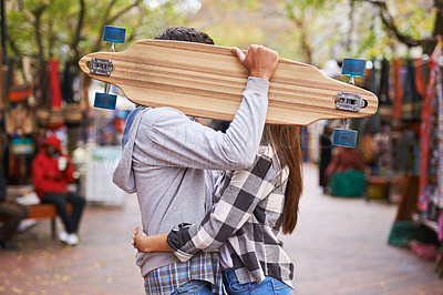 Buy stock photo Couple, hide with skateboard and outdoor in city, hug and excited to learn together and romantic relationship. Cape town, touch and hobby with boyfriend and girlfriend in street, love and dating