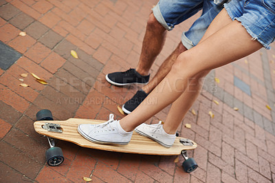 Buy stock photo Skateboard ride, legs and couple of friends teaching partner sports skills, exercise lesson or training on urban ground. Skate, cardio fitness or shoes of people helping, coaching and support balance