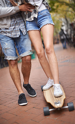 Buy stock photo Skateboard ride, legs and learning couple of friends teaching partner sports skills, exercise lesson or practice movement. Skate shoes, date and outdoor people helping, coaching and support balance