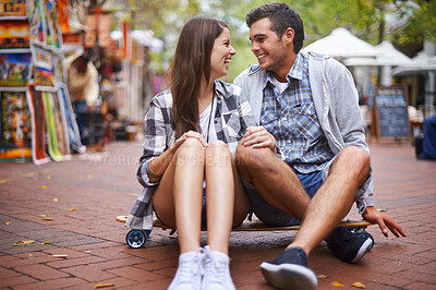 Buy stock photo Couple, travel on skateboard and happy in city, outdoor and conversation with partner, learn together and relationship. Cape town, fun and hobby with boyfriend and girlfriend in street, love or date