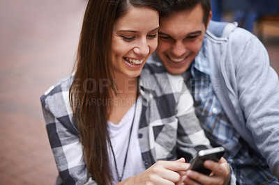 Buy stock photo Phone, smile and couple browsing social media together for love, communication or bonding on campus. App, education or internet with student man and woman reading university information on mobile