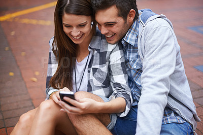 Buy stock photo Outdoor, smile and couple with smartphone connection and marriage with internet, typing and social media. Relationship, man and woman with cellphone, digital app and contact with email, funny or joy