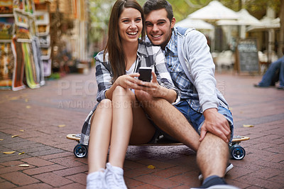 Buy stock photo Couple, sitting on skateboard and portrait with phone, happy and social media with partner, scrolling and relationship. Cape town, fun and hobby with boyfriend and girlfriend in street, love or date