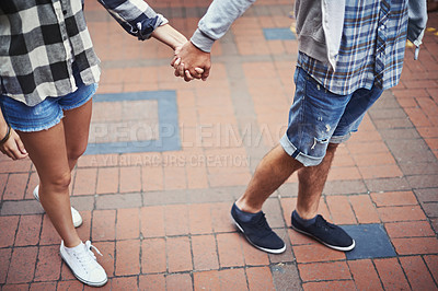 Buy stock photo Legs, walking and couple holding hands on relax journey, morning trip and weekend tour for outdoor adventure. Love, ground and romantic people commute together on street, road or sidewalk floor