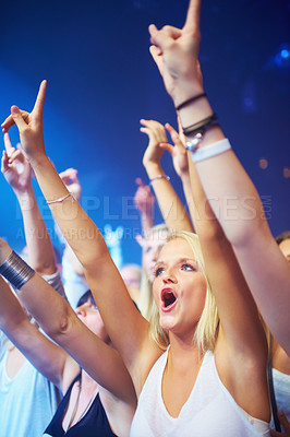 Buy stock photo Woman, crowd and cheering at concert for live performance at music festival for entertainment, brand or listening. Female people, hands up and celebrate for dj musician or rave weekend, party or fans
