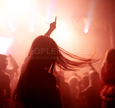 Buy stock photo Dancing, club and back of woman at a concert, disco event or psychedelic trance festival. Night, energy and female person doing dance or moving to a song with red light at techno party or show.