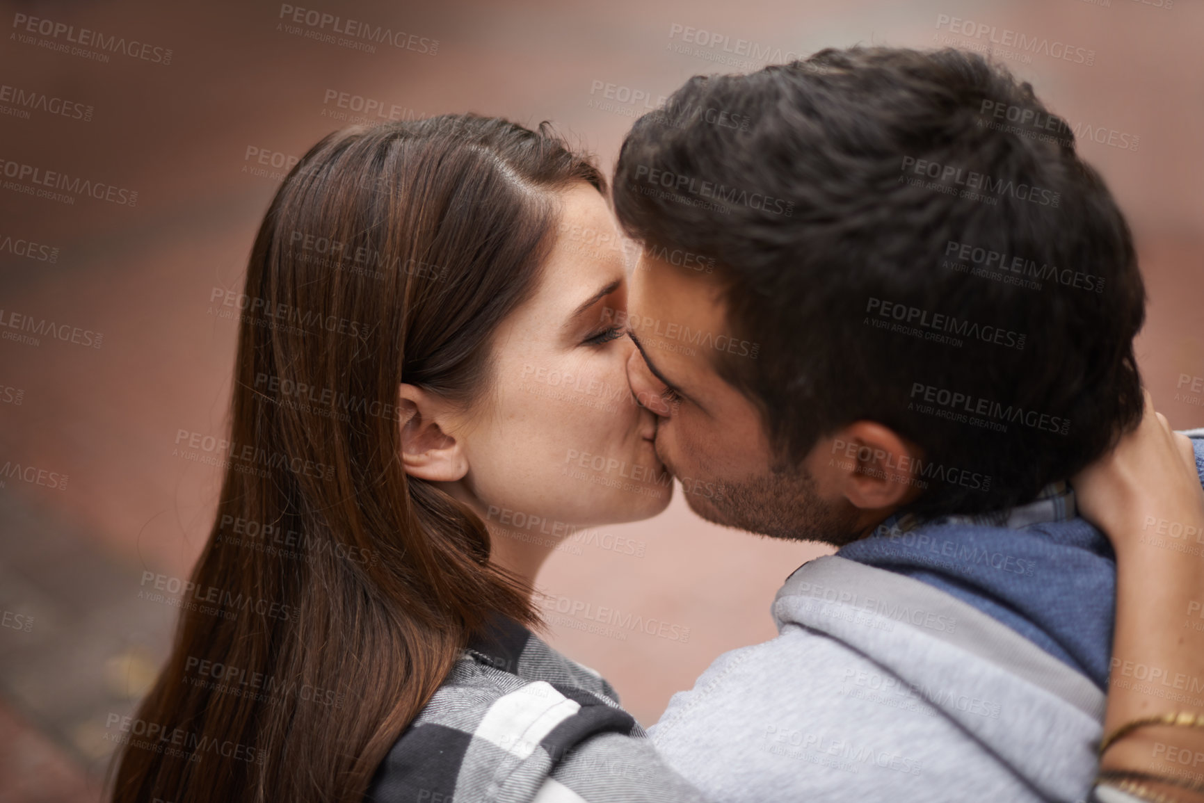 Buy stock photo Love, city and face of couple kiss, bonding together and enjoy outdoor date with care, support and partner commitment. Devotion, relationship connection and romantic people in sweet intimate moment 