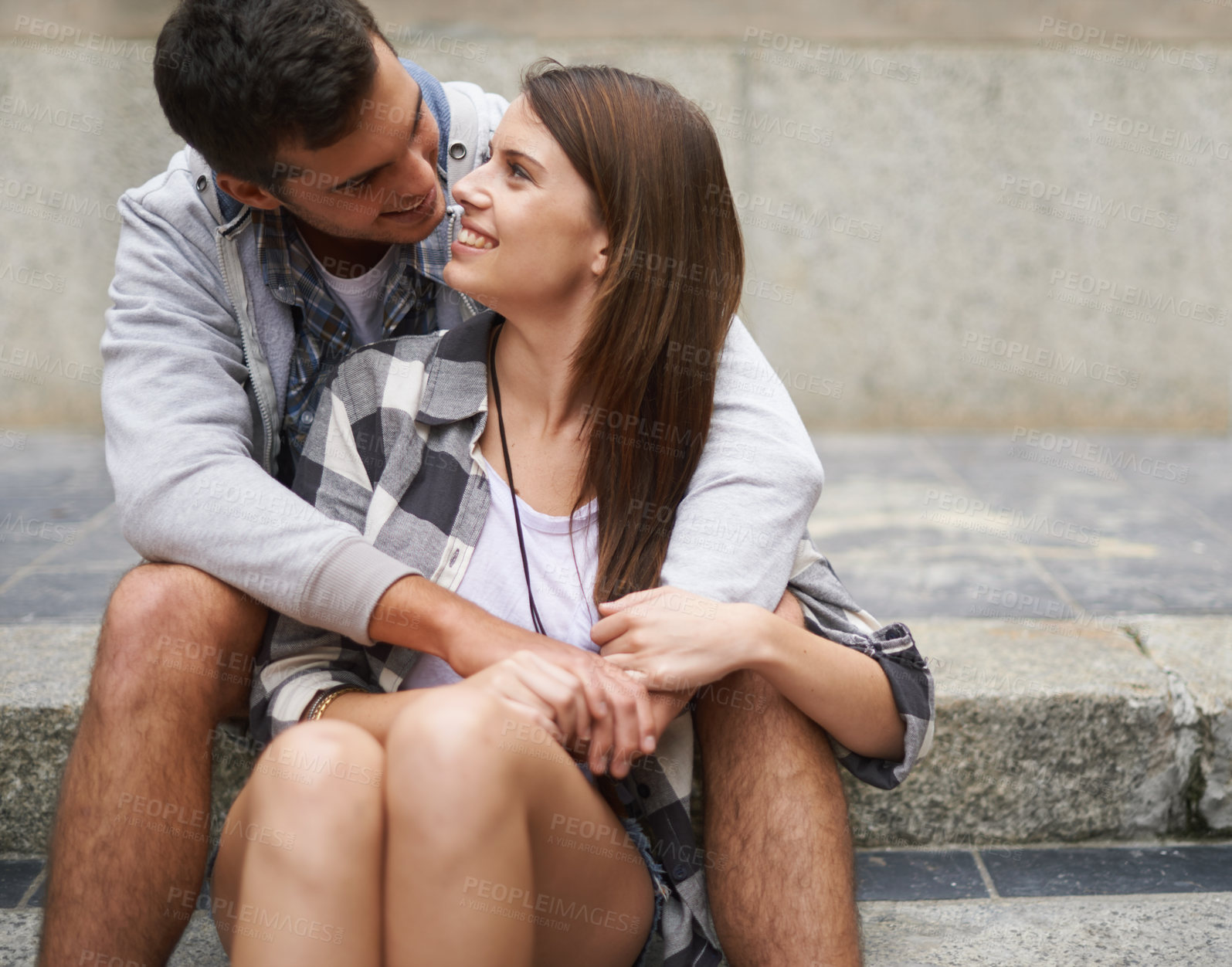 Buy stock photo Smile, steps and relax couple hug, bond and enjoy date on marriage honeymoon, Valentines Day or anniversary. Urban staircase, love and gen z people trust in relationship, eye contact or devotion