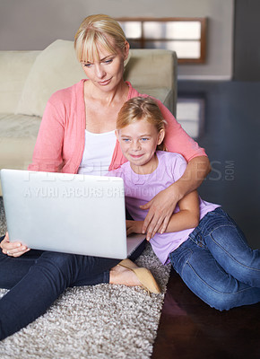 Buy stock photo Mother, child and streaming movie on laptop, internet connection and relaxing on living room floor. Mommy, daughter and subscription to entertainment, happy and website for series and online game