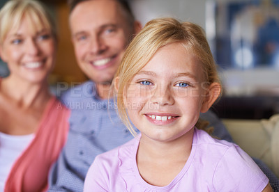 Buy stock photo Portrait, smile and child in home with family, bonding and love together for childhood in the living room. Face, happy girl and young kid relax in lounge with parents, mother and father in house