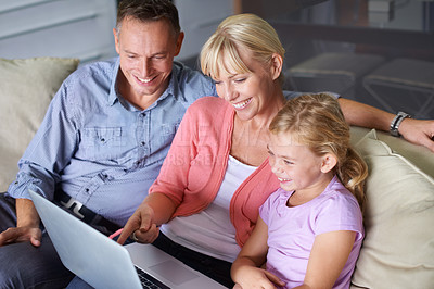 Buy stock photo Family, laptop and parents with daughter on sofa in living room of home for entertainment streaming. Love, smile or happy with mother, father and girl children watching video on computer in apartment