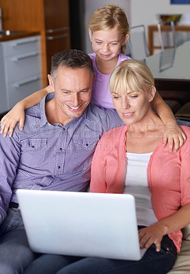 Buy stock photo Family, laptop and parents with girl on sofa in living room of home for entertainment streaming. Love, smile or happy with mother, father and daughter watching online video on computer in apartment