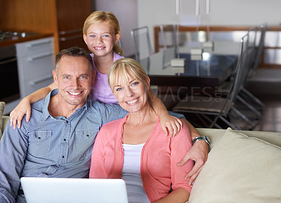 Buy stock photo Portrait, laptop and family on sofa in living room of home for entertainment streaming. Love, smile or happy with mother, father and girl child watching online video on computer in apartment