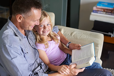 Buy stock photo Father, child and book for storytelling at home, reading and learning fiction for education. Daddy, daughter and bonding together on couch, literacy and support for language development or knowledge