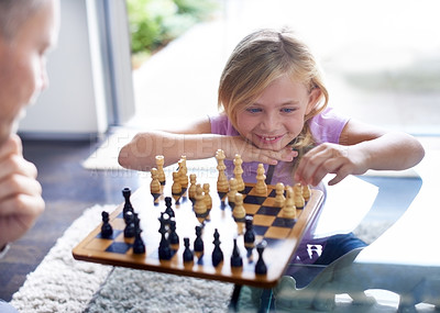 Buy stock photo Smile, kid and father play chess in home, family bonding together or development. Happy girl, man and board game of strategy, challenge or entertainment of young child in competition match in house