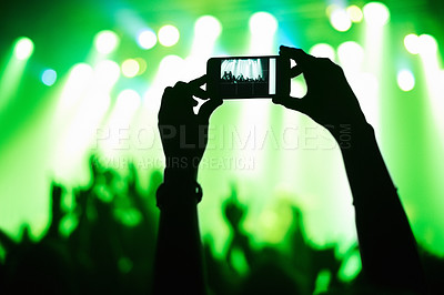 Buy stock photo A person filming their favorite band with a camera phone. This concert was created for the sole purpose of this photo shoot, featuring 300 models and 3 live bands. All people in this shoot are model released.