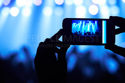 Buy stock photo Cropped shot of a person filming their favorite band with a camera phone. This concert was created for the sole purpose of this photo shoot, featuring 300 models and 3 live bands. All people in this shoot are model released.