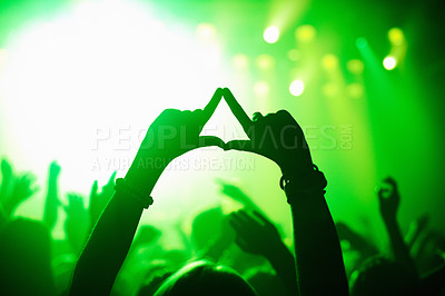 Buy stock photo Triangle hands, neon and person in concert audience for music, festival or performance on stage. Party, psychedelic and green light with crowd of people outdoor for event, disco or club celebration