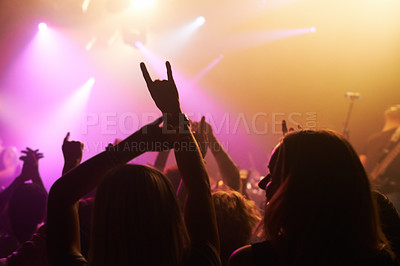 Buy stock photo Club, concert and audience with rock or sign for music, band and rave festival with spotlight, dancing or women. Disco, live event and performance with entertainment, crowd and rear view gesture