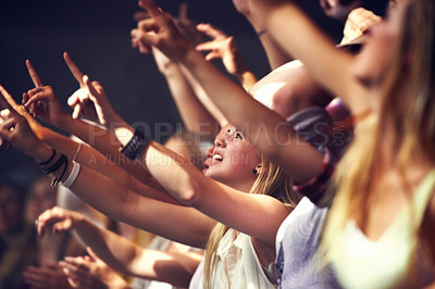 Buy stock photo Night, concert and fans dance to music, performance and audience with energy at festival. Crowd, support and people stretching hands in celebration or praise of rock, culture or excited at event